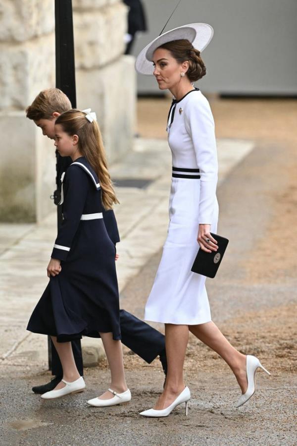 Princess Catherine in a white dress arrives with Prince George and Princess Charlotte for the Trooping the Colour parade in London