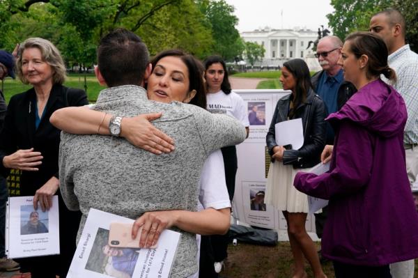 Neda Shargi, sister of Iranian priso<em></em>ner Emad Shargi, hugs former Syrian hostage Sam Goodwin before a news co<em></em>nference with families of Americans currently being held hostage on May 4, 2022, in Washington. 