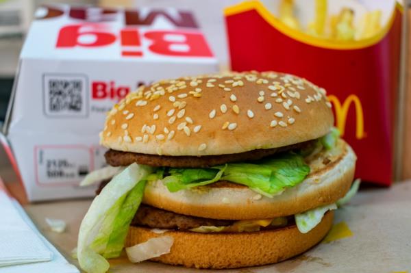 A Big Mac burger with its box and a carton of medium fries from McDonald's in London, UK on 01.28.2021