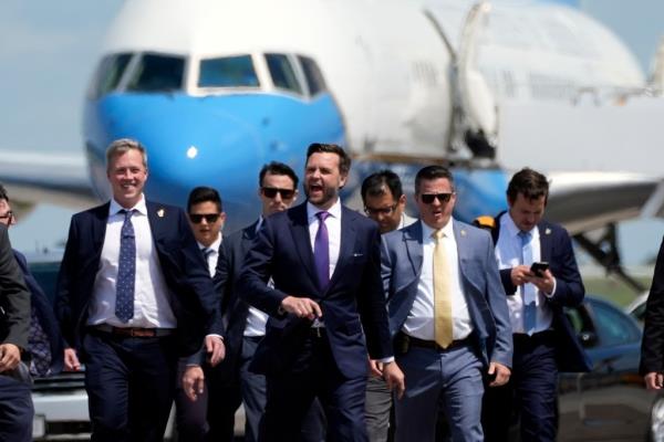 Republican vice presidential nominee Sen. JD Vance walks back from looking at Air Force Two at Chippewa Valley Regio<em></em>nal Airport in Wisconsin.