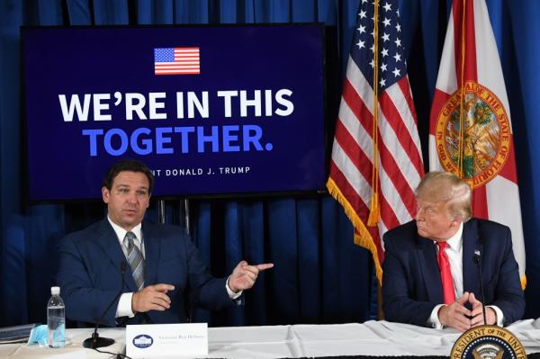 US President Do<em></em>nald Trump (R) and Florida's governor Ron DeSantis hold a COVID-19 and storm preparedness roundtable in Belleair, Florida, July 31, 2020.