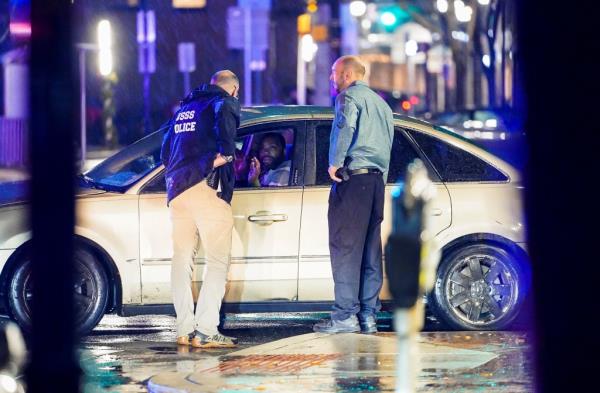 Members of the United States Secret Service speak to the driver of the vehicle that crashed into a Secret Service SUV.