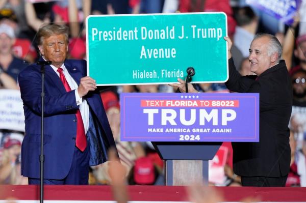 Former President Do<em></em>nald Trump holding a sign with Hialeah Mayor Esteban Bovo at a campaign rally in Hialeah, Florida on November 8, 2023.