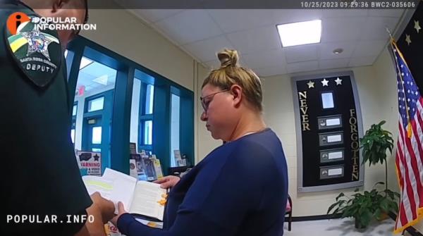 Tapley is seen showing a deputy the book.