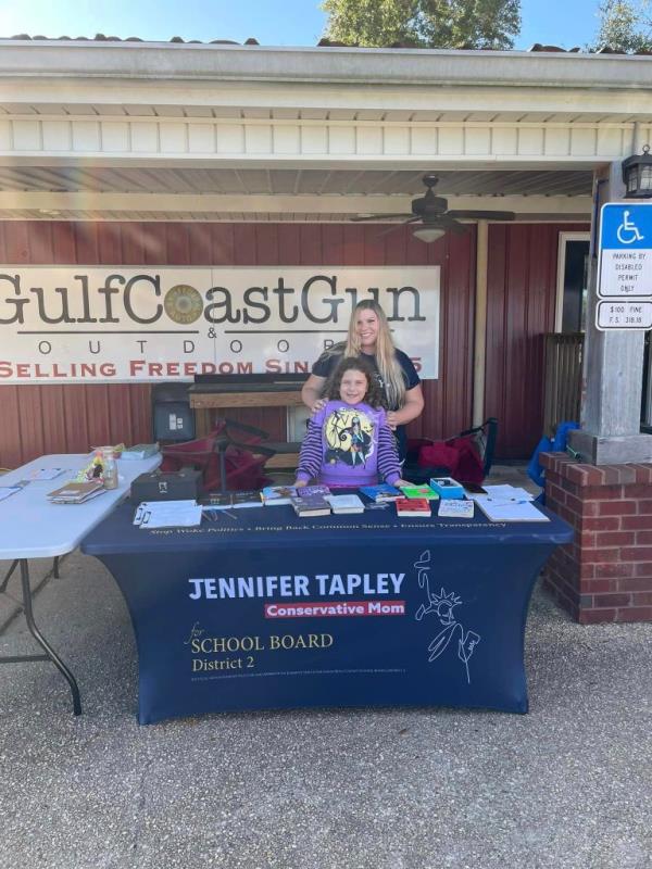 Jennifer Tapley is pictured campaigning with her daughter for school board.