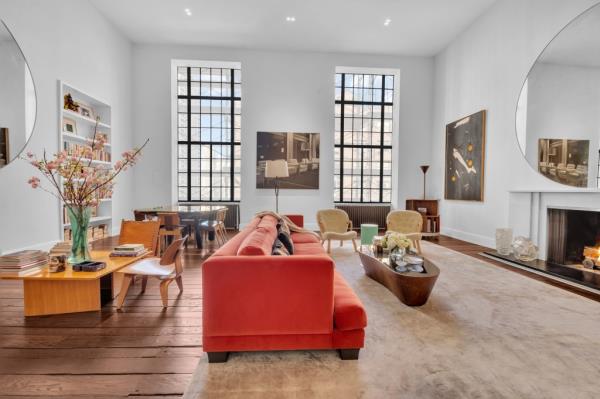 The double height living room with original casement windows.