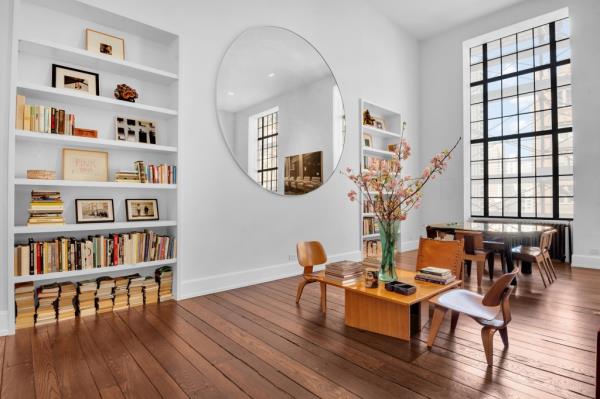 Design details include vintage restored wide plank hardwood floors and circular infinity mirrors. 