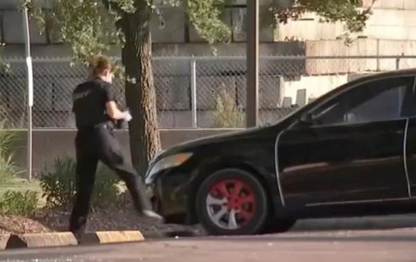 Police seen working at the scene of a baby's hot-car death in Houston