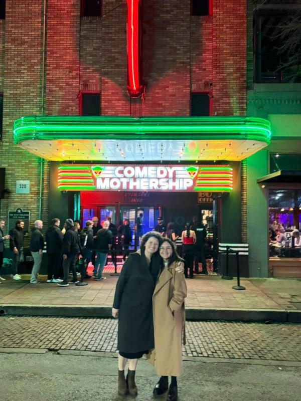 Nellie Bowles poses with her wife Bari Weiss in front of a theater.