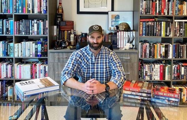 Author Jack Carr at a table surrounded by books