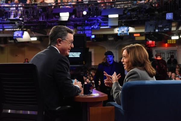 Stephen Colbert and Vice President Kamala Harris sitting at a table during The Late Show recorded on October 8, 2024.