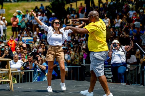 Rep. Alexandria Ocasio-Cortez, (D-NY) greets  Rep. Jamaal Bowman (D-NY) during a rally and canvass kick-off on the weekend before the New York Democratic Primary St. Mary's Park on JUNE 22, 2024 in the Bronx borough of New York City.