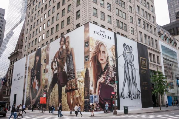 Coach store front at 685 5th Ave, NY, featuring a large mural with Edie Campbell, Lexi Boling, Gigi Hadid, Joan Smalls, Lily Aldridge, Helena Wong, and Tom Mandrake.