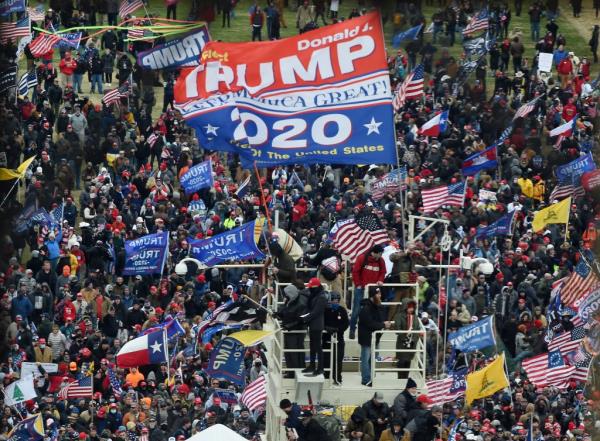 Supporters of Trump take over stands set up for the presidential inauguration as they protest at the US Capitol in Washington, DC, Jan. 6, 2021.