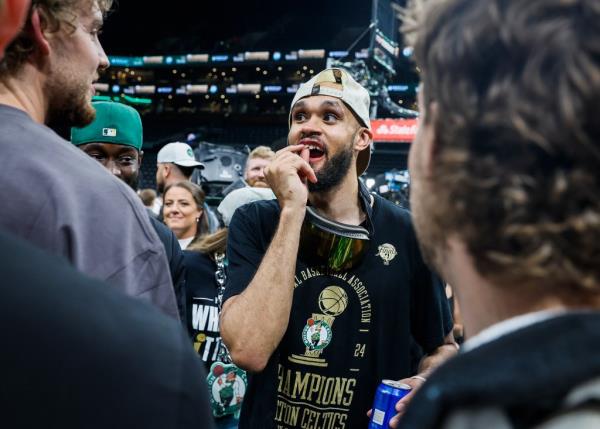 Derrick White touches his broken tooth.