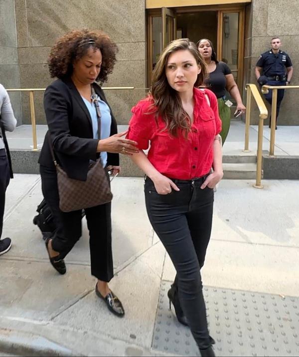 Jessica Mann leaving court, wearing a red shirt