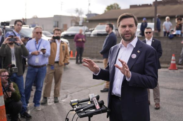 Vance speaks outside after voting.