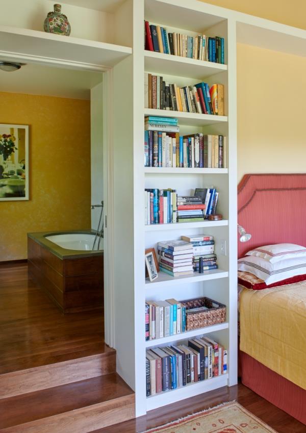 Interior of a bedroom with a bookcase.