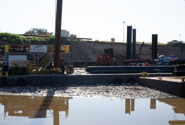 Trash floating around a co<em></em>nstruction barge at Buffalo Bayou in Houston. 