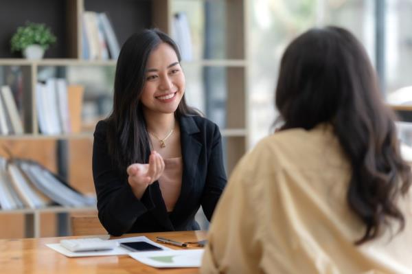 Two happy asian businesswoman talking and co<em></em>nsulting working together in the office.