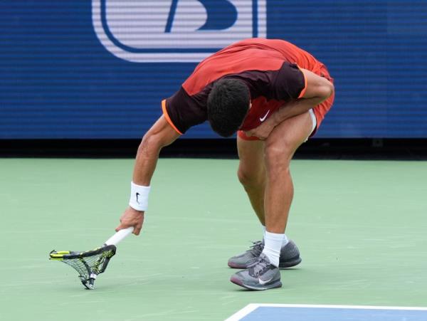 Carlos Alcaraz smashes his racket during his loss to Gael Monfils. 