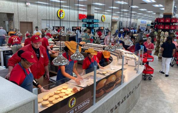 Staff members put barbecue sandwiches together at Buc-ee's in Auburn on Thursday, April 13, 2023