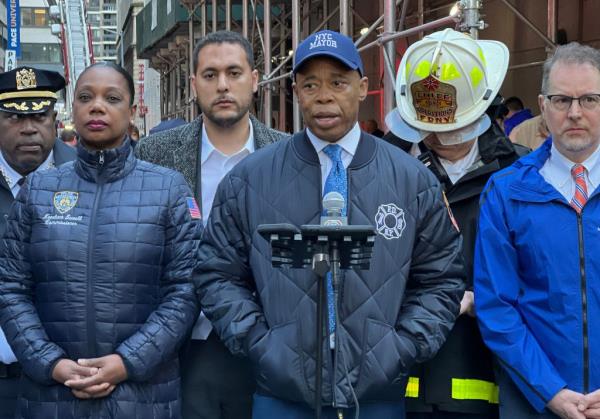 New York Police commissio<em></em>ner Keechant Sewell stands next to New York Mayor Eric Adams as he speaks on the scene of the parking garage collapse in New York City, on April 18, 2023. 