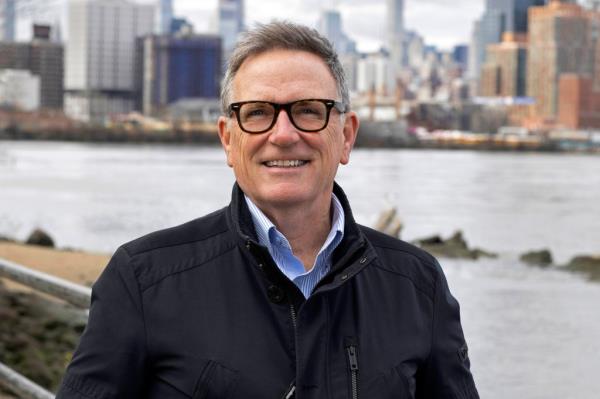 Marty Dolan stands in front of the New York City waterfront.