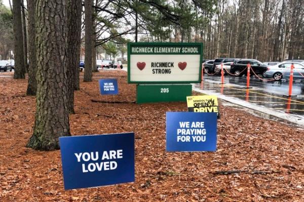 FILE - Signs stand outside Richneck Elementary School in Newport News, Va., on Jan. 25, 2023. The school is set to reopen Monday, Jan. 30, more than three weeks after a Jan. 6 shooting. Police have said a boy brought a 9mm handgun to school and intentio<em></em>nally shot his teacher, Abby Zwerner, as she was teaching her first-grade class. (AP Photo/Denise Lavoie, File)