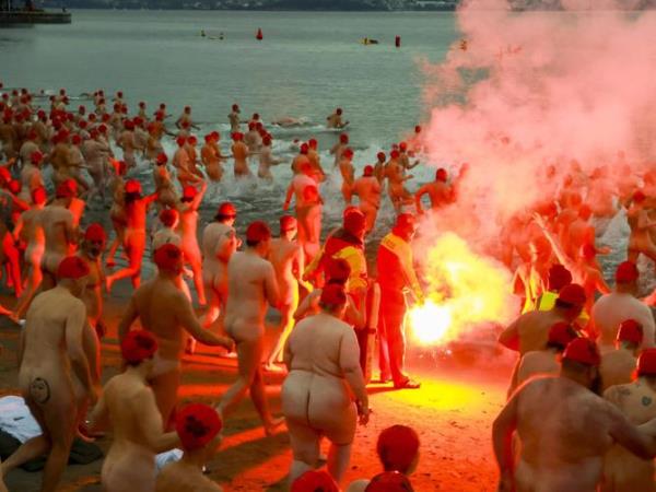 Brave swimmers gather round a fire before taking a dip in Tasmania’s Sandy Bay to welcome the winter solstice. NewsWire/Minch Media