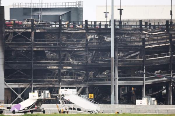 A charred section of a parking structure is seen after it caught fire and partially collapsed at London's Luton Airport on October 11, 2023. 