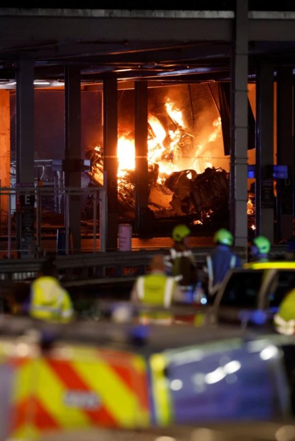 Flames are seen as emergency services respond to a fire in Terminal Car Park 2 at Lo<em></em>ndon Luton airport in Luton, Britain, October 10, 2023. REUTERS/Peter Cziborra