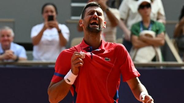 Novak Djokovic is overcome with emotion after his victory on Court Philippe-Chatrier at Roland Garros