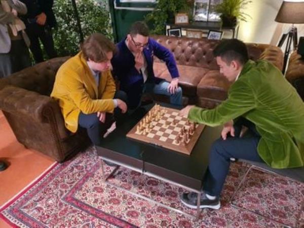 Germany's Keymer, American Caruana (both left) and Uzbekistan's Abdusattorov analyze Wednesday's opening position at the Weissenhaus tournament. 