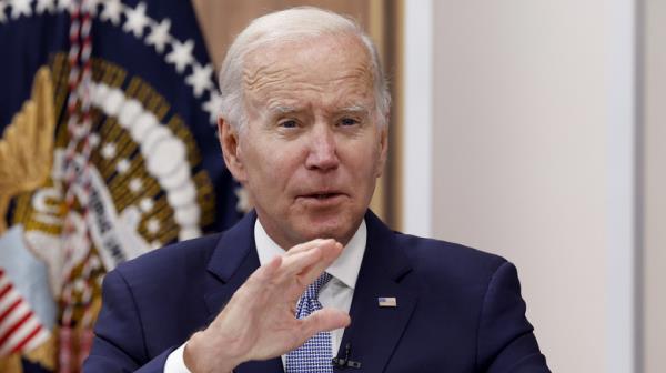 Joe Biden speaking with hand raised