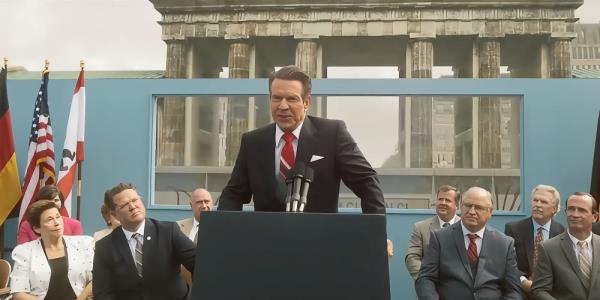 Dennis Quaid as Reagan at a press conference, demanding at the Berlin Wall be torn down in Reagan