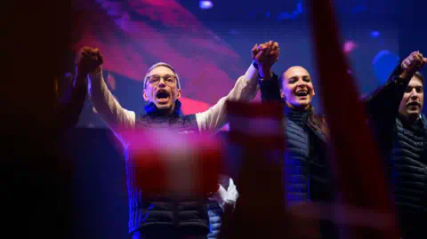 Getty Images Herbert Kickl, lead candidate of the far-right Austria Freedom Party (FPOe), cheers at an FPOe election rally ahead of Austrian parliamentary elections on September 27, 2024 in Vienna, Austria. 