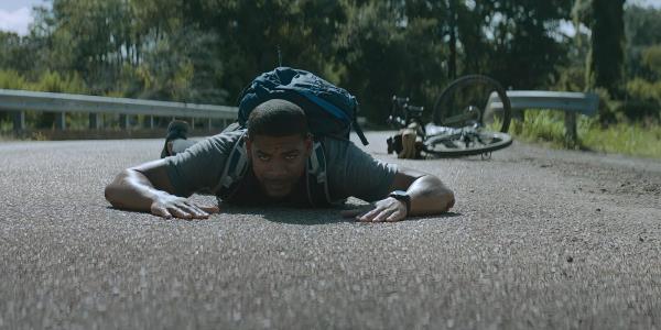 Terry Richmon lying on the ground in Rebel Ridge after being hit by a police car