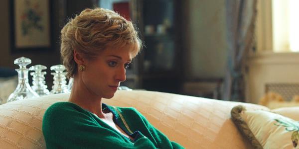 Elizabeth Debicki as Princess Diana sitting on a couch in a green sweater in The Crown season 6